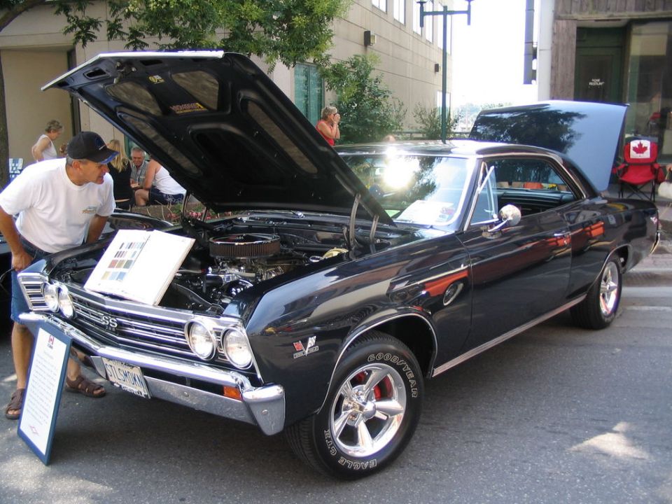 Black 1967 Chevrolet Chevelle SS with hood and trunk open, parked on street