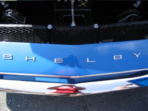 1993 Ford Taurus - Close-up of the SHELBY lettering on the front of a blue vehicle, classic car.