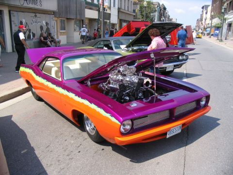 1993 Ford Taurus - Custom hot rod with a powerful engine on display at a car show.
