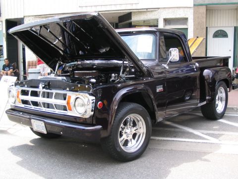 1993 Ford Taurus - This black pickup truck has its hood open, revealing the engine and chrome grille.