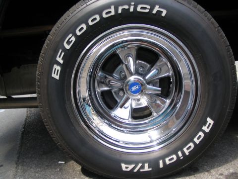 1993 Ford Taurus - BFGoodrich Radial T/A tire mounted on a chrome 5-spoke wheel with a Ford logo center cap.