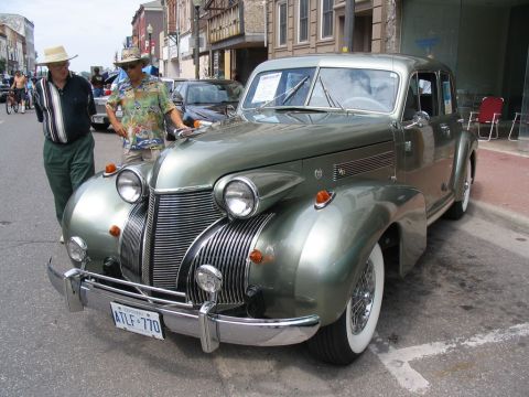 1993 Ford Taurus - A classic green automobile with a distinctive grille is on display at a car show.