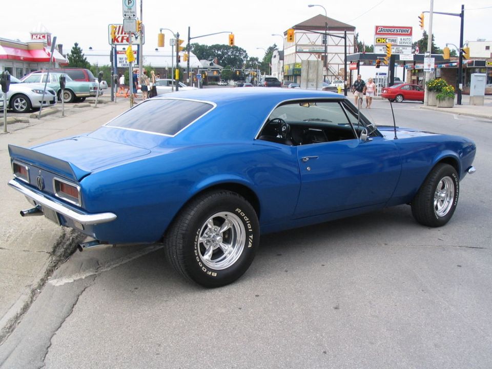 Blue 1967 Chevrolet Camaro parked on street, rear quarter view