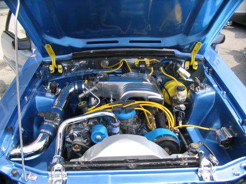 1993 Ford Taurus - The engine bay of a blue vehicle is shown with custom chrome and yellow accents. The registry incorrectly identifies it as a 1993 Ford Taur…