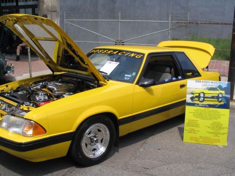 1993 Ford Taurus - A yellow 1988 Ford Mustang LX Express coupe is displayed with its hood and trunk open.