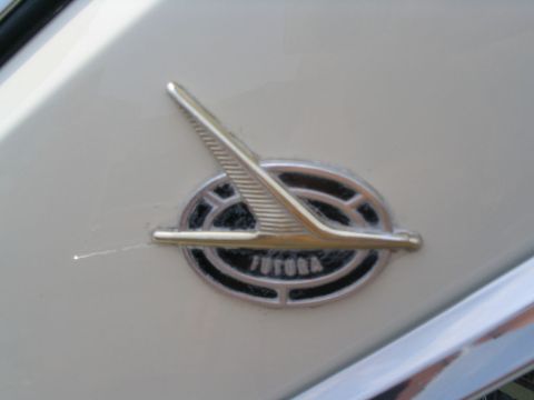 1993 Ford Taurus - Close-up of a 'FUTURA' emblem on a vehicle's exterior.
