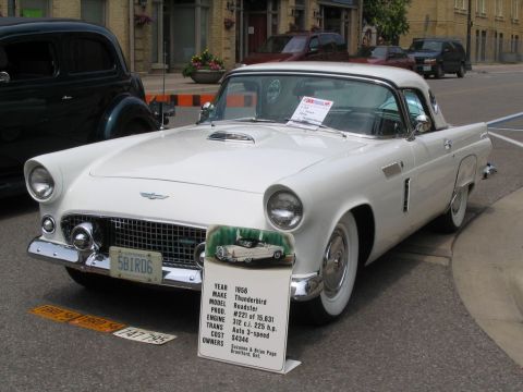 1993 Ford Taurus - A white 1956 Ford Thunderbird Roadster is displayed at a car show, with a sign providing its year, make, model, and other details.