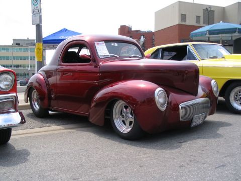 1993 Ford Taurus - A custom hot rod with a distinctive grille and rounded fenders is shown at an outdoor event.