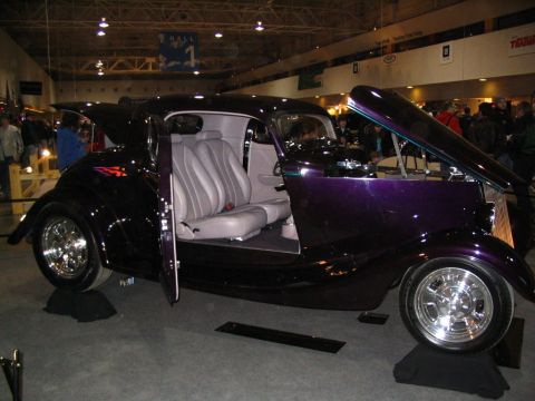 1993 Ford Taurus - Custom hot rod on display, custom paint and interior, with hood and doors open.