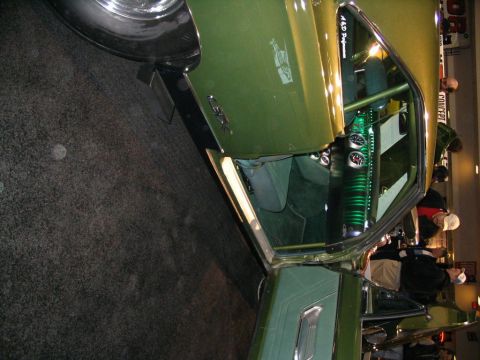1993 Ford Taurus - Custom interior of a green muscle car, a roll cage and multiple gauges.