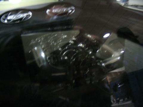 1993 Ford Taurus - A close-up view of a car's engine bay, shiny components and some visible text.