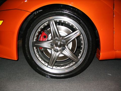 1993 Ford Taurus - Custom wheel and red brake caliper detail on an orange car.