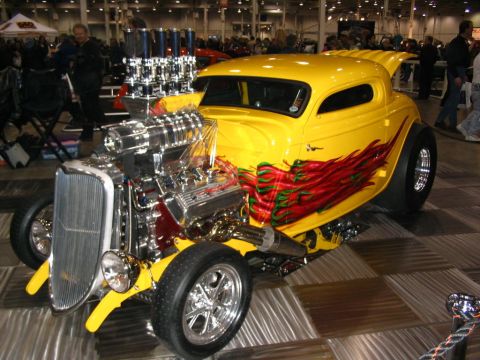 1993 Ford Taurus - This custom hot rod features a prominent exposed engine and a vibrant chili pepper flame graphic along its side.