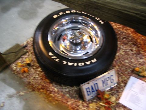 1993 Ford Taurus - A BFGoodrich Radial T/A tire on a chrome wheel is displayed with a "BAD MPG" license plate.