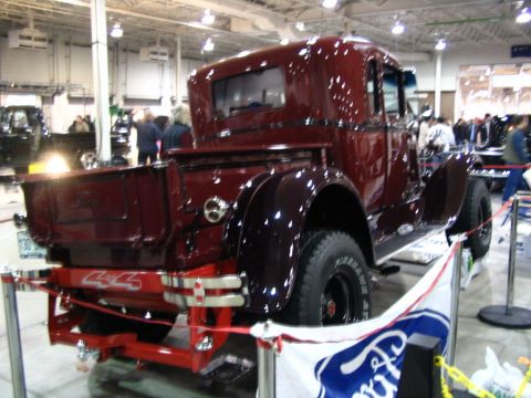 1993 Ford Taurus - Antique pickup truck displayed indoors with a Ford banner in the foreground.