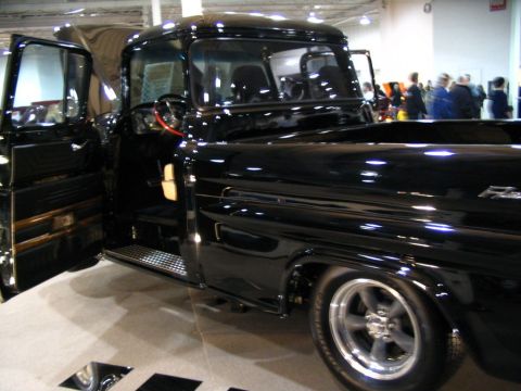 1993 Ford Taurus - A black pickup truck is displayed with its doors open, revealing its interior details.