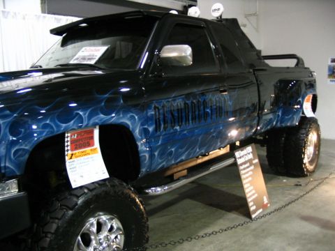 1993 Ford Taurus - Customized pickup truck with flame graphics and "RESURRECTION" text on its side.