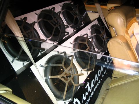 1993 Ford Taurus - Custom car audio installation multiple subwoofers and tan interior seating.