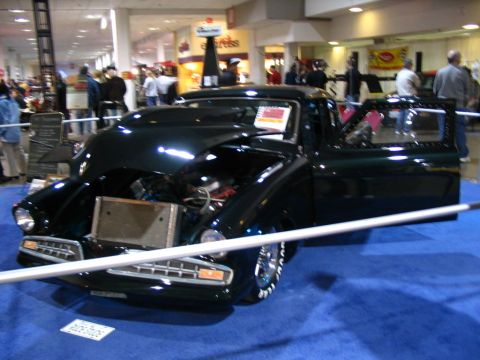 1993 Ford Taurus - Custom pickup truck on display with its hood open and door ajar.