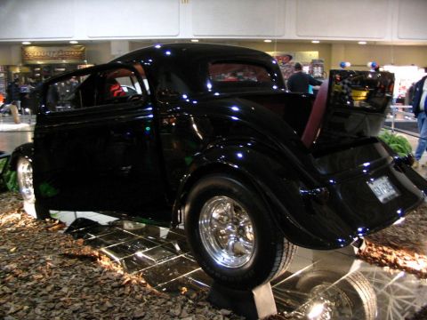 1993 Ford Taurus - Custom hot rod coupe displayed indoors with a unique presentation on the floor.