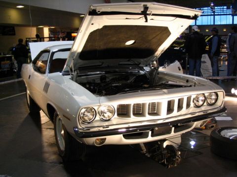 1993 Ford Taurus - White 1970 Plymouth Barracuda displayed indoors with its hood raised.