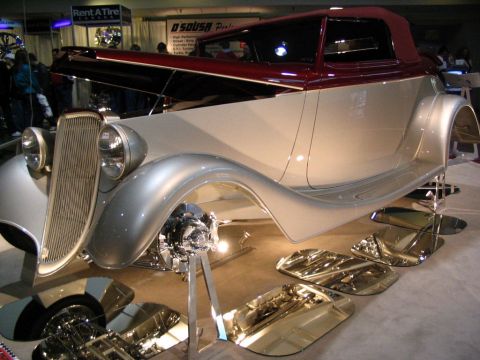 1993 Ford Taurus - Custom hot rod on display at an auto show, a two-tone paint scheme and polished metal accents.