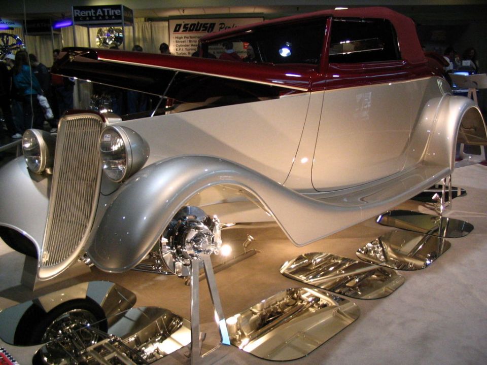 Custom hot rod with two-tone paint and exposed engine components on display