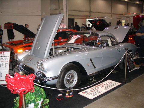 1993 Ford Taurus - A classic 1962 Corvette is displayed with its hood open at a car show.