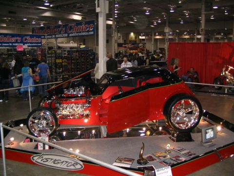 1993 Ford Taurus - A custom hot rod named 'Instigator' is displayed with its hood open, revealing a powerful engine.
