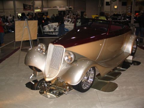 1993 Ford Taurus - A custom hot rod with a maroon top and silver body is displayed indoors on a polished floor.