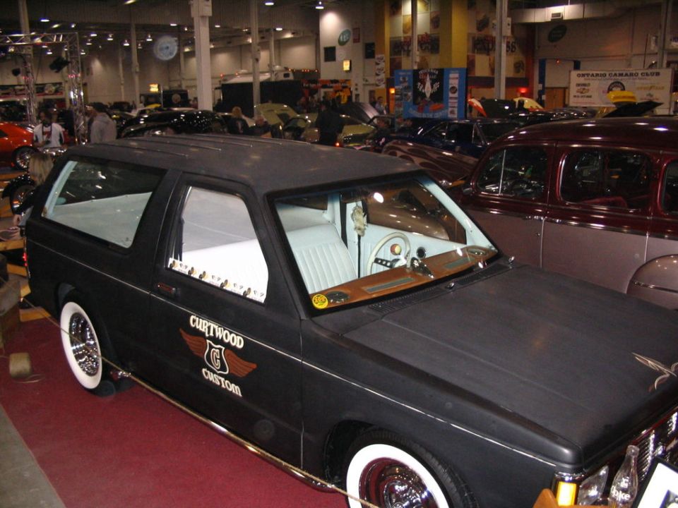 Black custom SUV with white wall tires and 'Curtwood Custom' decal