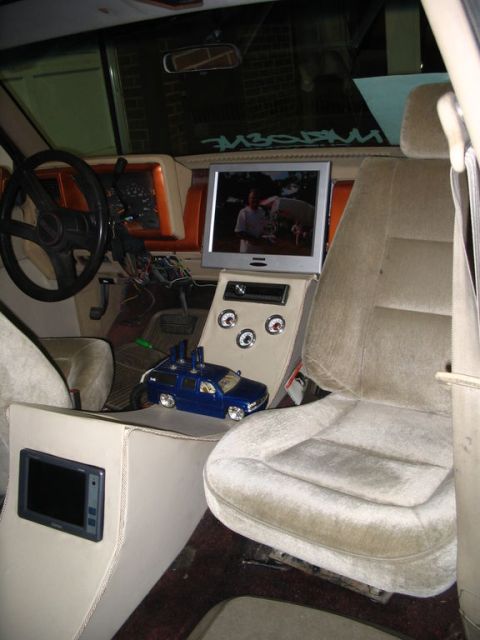 1993 Ford Taurus - Interior view of a modified van, multiple screens and custom console elements.