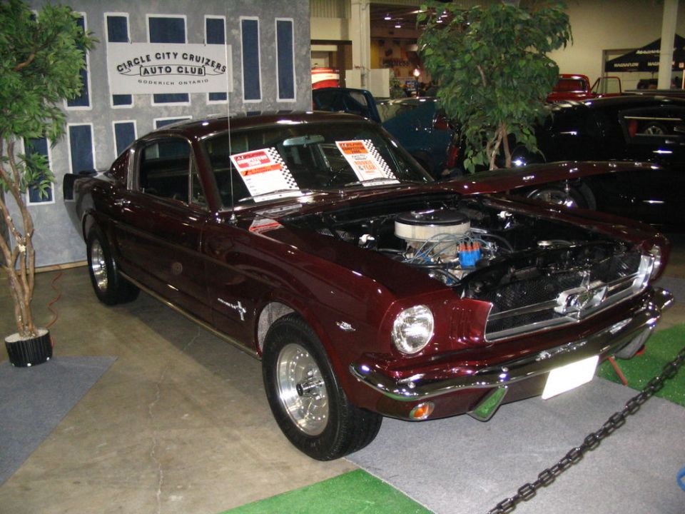 Maroon 1965 Ford Mustang coupe, hood open, front 3/4 view