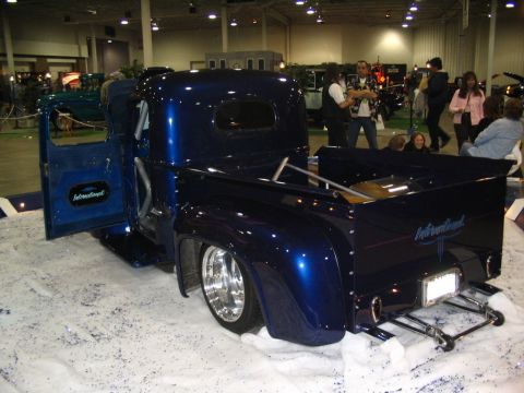 1993 Ford Taurus - A customized International pickup truck is displayed indoors with its door open, its interior and custom paint.
