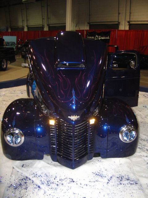 1993 Ford Taurus - Custom hot rod with flames and chrome details on display.