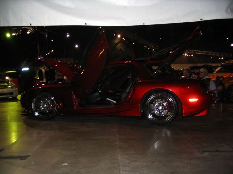 1993 Ford Taurus - Custom red sports car with unique doors and hood displayed indoors.