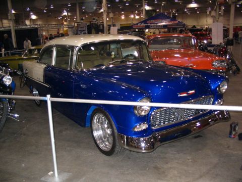 1993 Ford Taurus - Customized 1955 Chevrolet Bel Air on display indoors, with another car visible behind it.