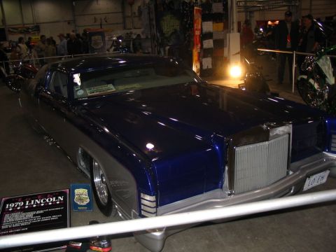 1993 Ford Taurus - A customized 1979 Lincoln Mark V is displayed indoors, a striking two-tone paint job and prominent chrome grille.