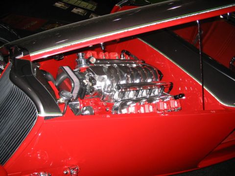1993 Ford Taurus - Close-up of a polished V8 engine, likely from a custom build, with red body panels.