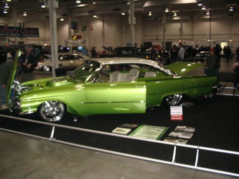 1993 Ford Taurus - A custom lime green and white two-door hardtop car is displayed with its hood and doors open.