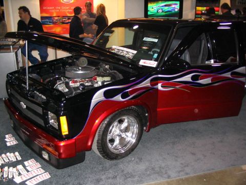1993 Ford Taurus - Customized pickup truck with flames and an open hood displaying the engine. The grille suggests a 1993 model year.