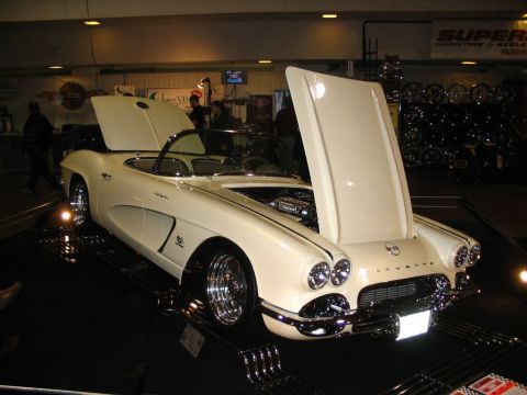 1993 Ford Taurus - A classic white Chevrolet Corvette is displayed with its hoods open, revealing the engine bay.
