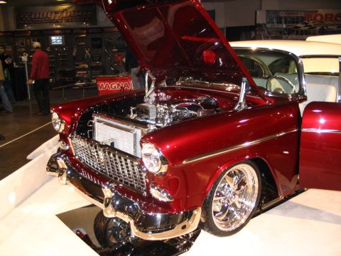 1993 Ford Taurus - A classic 1955 Chevrolet Bel Air is displayed with its hood open, revealing a polished engine and chrome details.