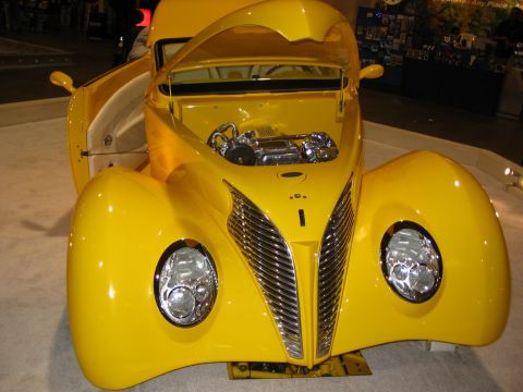 1993 Ford Taurus - A bright yellow custom car is displayed with its hood and driver's side door open, revealing the engine and interior.