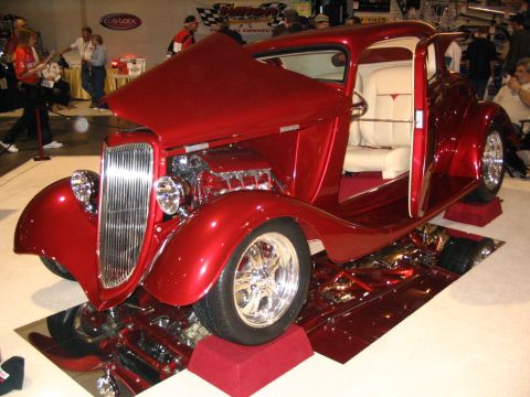 1993 Ford Taurus - Custom hot rod coupe displayed with hood open, revealing its engine and chrome details.