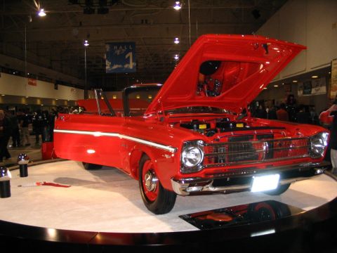 1993 Ford Taurus - This red convertible, likely from the early 1960s, is displayed with its hood and door open.