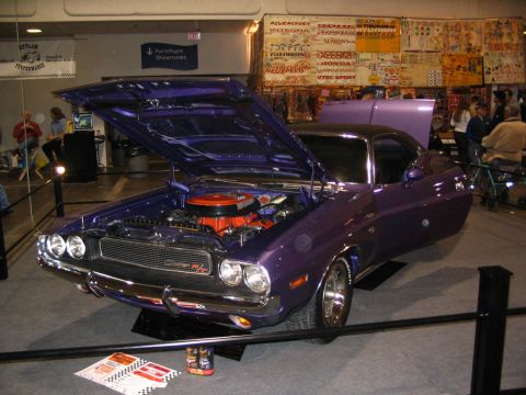 1993 Ford Taurus - A classic purple Dodge Challenger R/T is displayed with its hood open, revealing the engine.