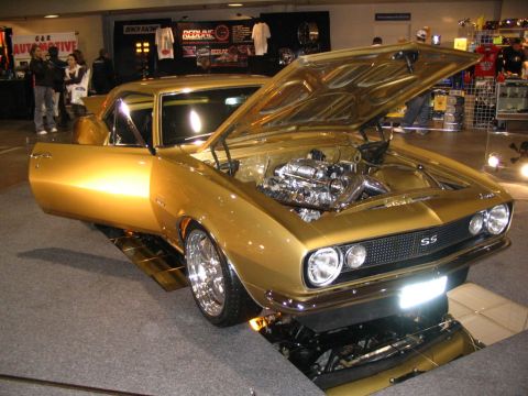 1993 Ford Taurus - This gold 1967 Chevrolet Camaro SS features a highly detailed chrome engine and an open driver's side door.