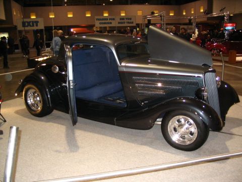 1993 Ford Taurus - This custom hot rod is displayed with its door and hood open at an indoor event.