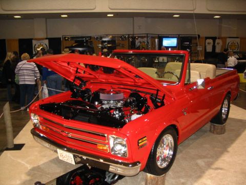 1993 Ford Taurus - A bright red 1972 Chevrolet K5 Blazer convertible is displayed with its hood open, revealing the engine and chrome accents.